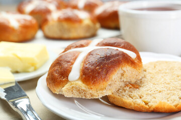 Tasty hot cross bun served on table, closeup