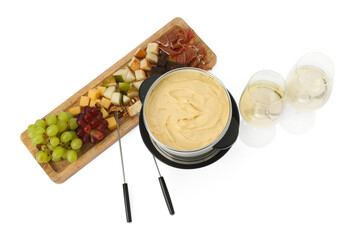 Fondue with tasty melted cheese, forks, different snacks and wine isolated on white, top view