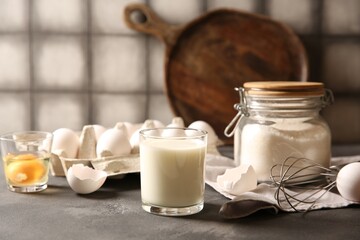 Different ingredients for dough on grey table, closeup