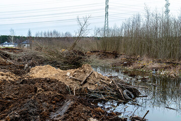 Excavated swamps with high groundwater, visible garbage and peat.