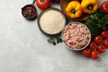 Making stuffed peppers. Ground meat and other ingredients on grey table, flat lay. Space for text