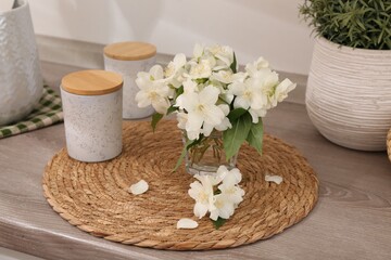 Beautiful jasmine flowers on wooden table indoors