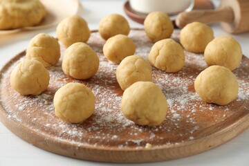 Shortcrust pastry. Raw dough balls on white table, closeup