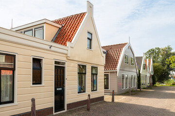 Traditional wooden picturesque houses in the small narrow Dutch village of Zunderdorp.