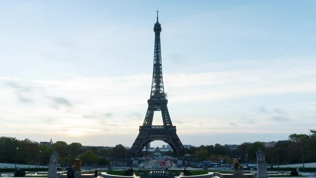 Timelapse Paris from early morning to sunrise, highlighting the Eiffel Tower. The city awakens as dawn breaks, Seine River and bridges. The Eiffel Tower stands majestically, showcasing Paris's charm