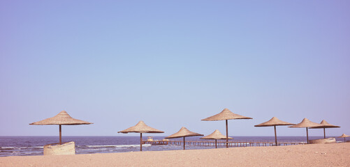 Retro toned photo of a beach with sun umbrellas, Egypt.