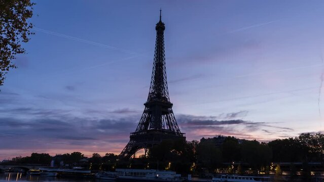 Timelapse Paris from early morning to sunrise, highlighting the Eiffel Tower. The city awakens as dawn breaks, Seine River and bridges. The Eiffel Tower stands majestically, showcasing Paris's charm