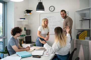 A language professor instructs students in foreign language at a diverse language school.	