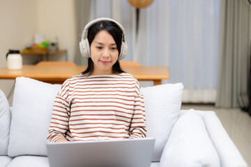 Woman study on laptop computer with her headphone