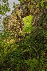 A Rock Arch Formation In The Woods During Spring