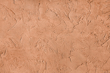 grunge decorative wall background. Art rough texture trendy color 2024 Peach Fuzz