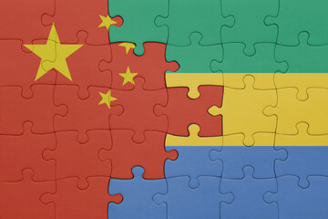 puzzle with the colourful national flag of gabon and flag of china .