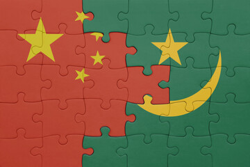 puzzle with the colourful national flag of mauritania and flag of china .