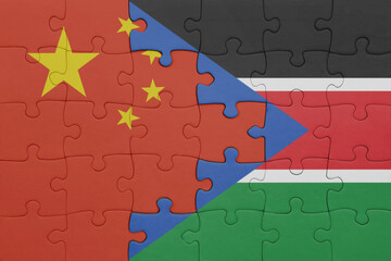 puzzle with the colourful national flag of south sudan and flag of china .