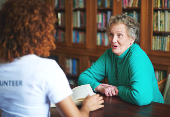 Talking, reading and senior woman with volunteer in retirement home for community service, social...