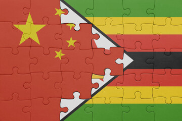 puzzle with the colourful national flag of zimbabwe and flag of china .