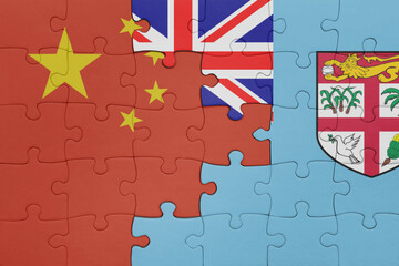 puzzle with the colourful national flag of Fiji and flag of china .