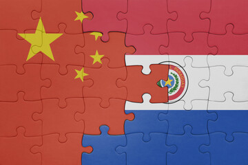 puzzle with the colourful national flag of paraguay and flag of china .