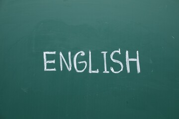 Word English written with chalk on green board