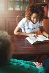 Volunteer, reading and happy black woman with book in retirement home for community service,...