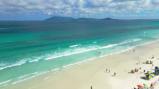 Aerial view of white dunes of the beach Cabo Frio with azure sea in Rio de Janeiro, Brazil.