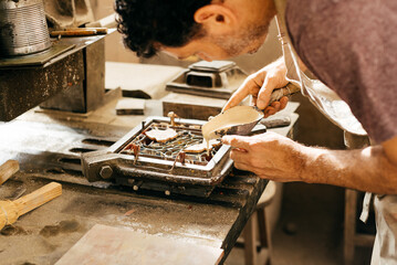 Man Carefully Applying Colors to Hydraulic Tile Mold in Artisan Workshop