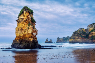 Early morning at Praia Dona Ana beach, with its spectacular sea stacks and cliffs in Lagos, Algarve, Portugal.	