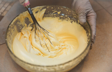 hands delicately layering ingredients to create a luscious tiramisu, showcasing the artistry of...