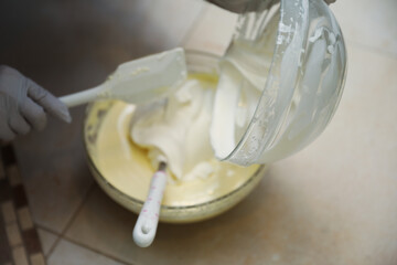 hands delicately layering ingredients to create a luscious tiramisu, showcasing the artistry of homemade desserts