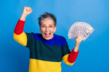 Photo of cheerful rich glad woman wear trendy clothes hold banknotes isolated on blue color...