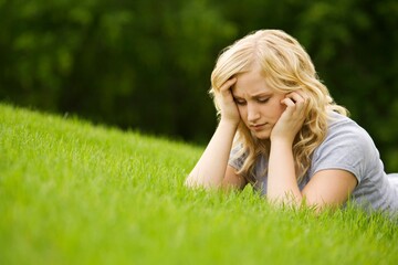 Fototapeta premium Young Woman Lying On Grass