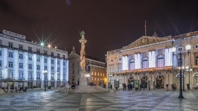 Panorama showing Municipal square with City Hall architecture decorated for Christmas and night celebrations night timelapse. People walking around. Lisbon, Portugal