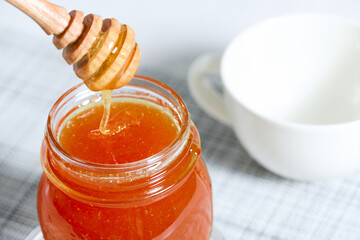 Jar of honey with dipper