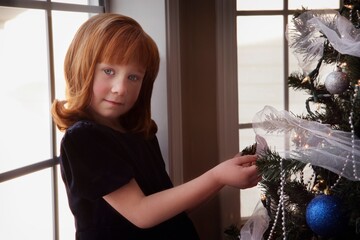 Little Girl Decorating Christmas Tree