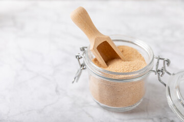 Cinnamon sugar on a texture background. Homemade cinnamon sugar in a bowl on background. Brown...