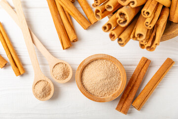 Cinnamon sugar on a texture background. Homemade cinnamon sugar in a bowl on background. Brown sugar. Spice mixture for drinks and baking. Place for text. Copy space.