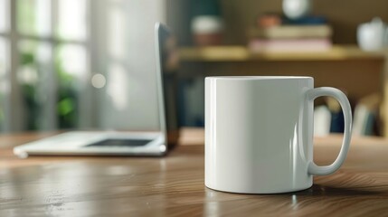A white mug mockup sitting on an office table with a laptop in a blurred background. A coffee cup and computer
