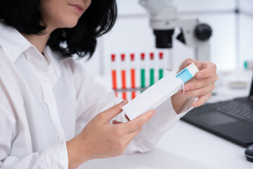 a girl medical worker takes out a medicine from a white cardboard package