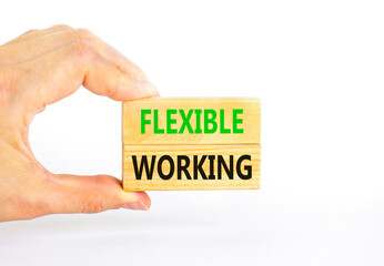 Flexible working symbol. Concept words Flexible working on beautiful wooden block. Beautiful white paper background. Businessman hand. Business flexible working concept. Copy space.