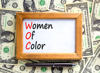 WOC women of color symbol. Concept words WOC women of color on beautiful wooden frame. Beautiful...