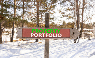 Property portfolio symbol. Concept words Property portfolio on beautiful wooden road sign. Beautiful winter forest snow tree background. Business Property portfolio concept. Copy space.