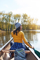 Woman, water and thinking on lake canoeing, wellness hobby and single blade paddle for rowing. Vacation, relax and explore exercise on travel in summer, canoe boat and trees on river for fitness