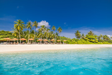 Empty beach with beach bar. Leisure loungers with sun beds and umbrellas. Tropical scene, luxury...