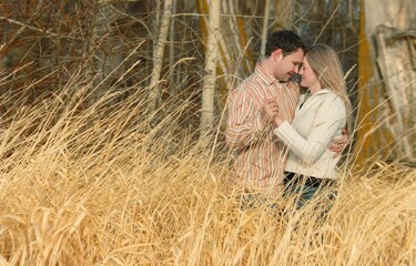 Couple Holding Each Other In A Field Of Wheat