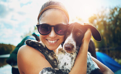 Portrait, woman and dog with love for camping in forest, sunshine and bond for smile by support of...