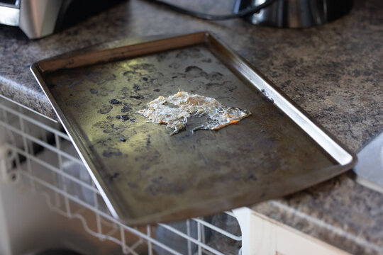 Neglected food residue on kitchen baking sheet