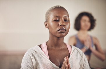 Black woman, namaste and peace for meditation with yoga for holistic wellness, mental health and healing in class. Girl, person and prayer hands for mindfulness, stress relief or zen with eyes closed