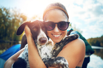 Woman, portrait and dog with love for camping in forest, sunshine and together for smile by support of adventure time. Happy, female person and puppy as pet with care, hug or relax in summer journey