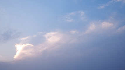 Sky background when a sunset behind the horizon. Background of white and blue sky gradient with copy space. Close-up sky and white clouds background for concept of a scene, nature view, and landscape.