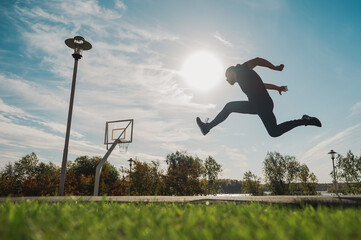 Caucasian man jumping with high hip raise outdoors. 
